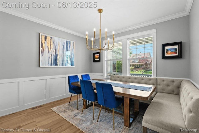 707 S Altadena Ave, Royal Oak, MI 48067 - dining space featuring a chandelier, ornamental molding, light wood-style flooring, breakfast area, and a wainscoted wall
