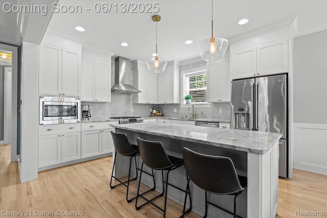 707 S Altadena Ave, Royal Oak, MI 48067 - kitchen featuring wall chimney exhaust hood, stainless steel appliances, white cabinets, a center island, and ornamental molding