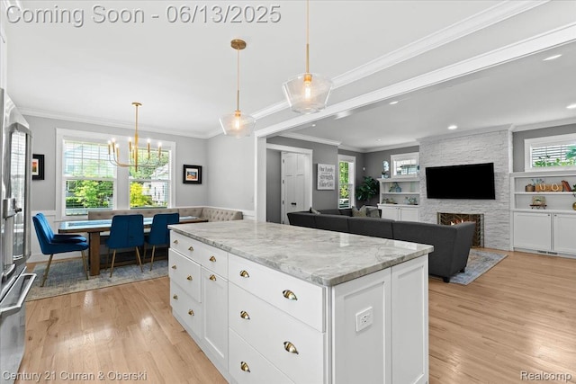 707 S Altadena Ave, Royal Oak, MI 48067 - kitchen with light wood-style flooring, a chandelier, white cabinetry, crown molding, and recessed lighting