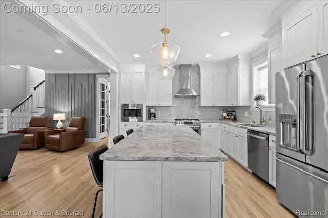 707 S Altadena Ave, Royal Oak, MI 48067 - kitchen featuring appliances with stainless steel finishes, wall chimney exhaust hood, tasteful backsplash, ornamental molding, and light wood-style flooring