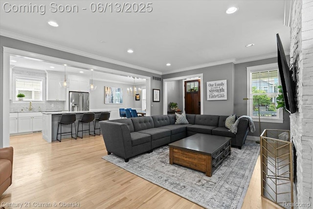 707 S Altadena Ave, Royal Oak, MI 48067 - living room with plenty of natural light, light wood-style floors, a chandelier, recessed lighting, and crown molding