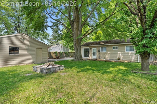 35245 Wick Rd, Romulus, MI 48174 - view of yard with an outdoor fire pit and an outdoor structure