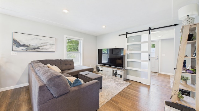 1204 Witham Rd, Muskegon, MI 49445 - living room featuring a barn door, wood finished floors, and recessed lighting