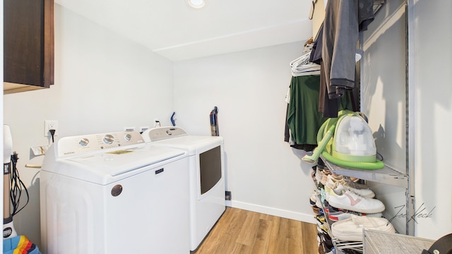 1204 Witham Rd, Muskegon, MI 49445 - washroom with independent washer and dryer, cabinet space, and light wood finished floors
