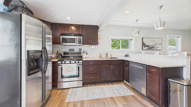 1204 Witham Rd, Muskegon, MI 49445 - kitchen with stainless steel appliances, a peninsula, light wood-type flooring, plenty of natural light, and beamed ceiling