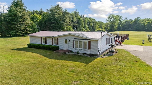 8031 Vassar Rd, Millington, MI 48746 - view of front of property with a front lawn, a metal roof, and driveway