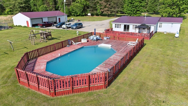 8031 Vassar Rd, Millington, MI 48746 - view of swimming pool featuring a deck, a lawn, and an outdoor structure
