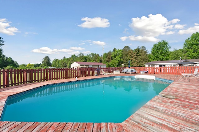 8031 Vassar Rd, Millington, MI 48746 - view of pool featuring a wooden deck and view of wooded area