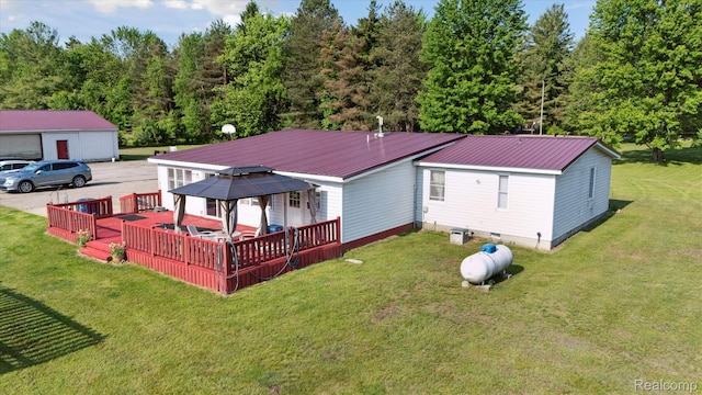 8031 Vassar Rd, Millington, MI 48746 - rear view of house featuring a gazebo, a wooden deck, a metal roof, a yard, and a garage