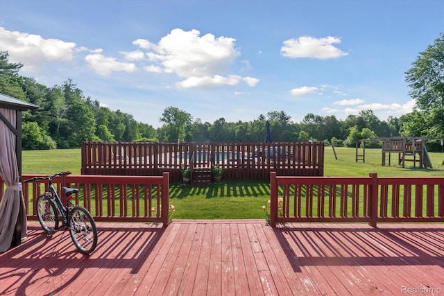8031 Vassar Rd, Millington, MI 48746 - wooden deck featuring a yard, a playground, and view of scattered trees