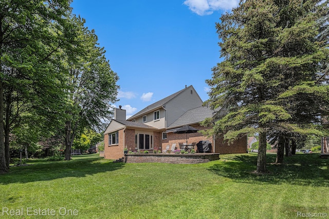 2842 Manorwood Dr, Troy, MI 48085 - rear view of house featuring brick siding, a lawn, and a chimney