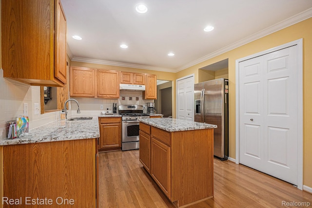 2842 Manorwood Dr, Troy, MI 48085 - kitchen featuring appliances with stainless steel finishes, light wood-style flooring, light stone counters, a kitchen island, and under cabinet range hood
