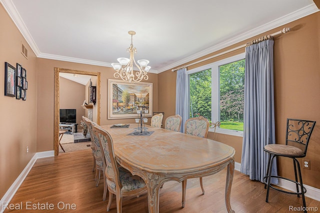 2842 Manorwood Dr, Troy, MI 48085 - dining area with light wood finished floors, crown molding, and a chandelier
