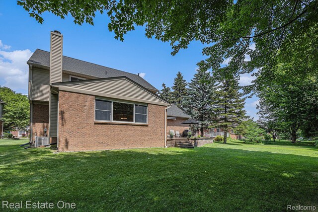 2842 Manorwood Dr, Troy, MI 48085 - view of home's exterior with brick siding, a yard, and a chimney