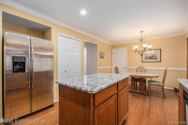 2842 Manorwood Dr, Troy, MI 48085 - kitchen featuring stainless steel refrigerator with ice dispenser, light wood-type flooring, ornamental molding, light stone countertops, and a chandelier