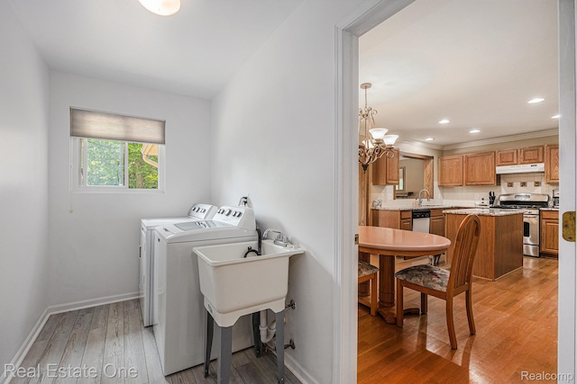 2842 Manorwood Dr, Troy, MI 48085 - laundry area with washing machine and dryer, light wood-style floors, a chandelier, and recessed lighting