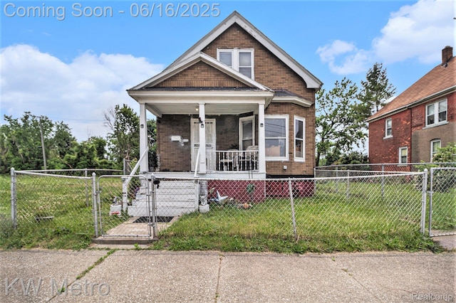 3620 Holborn St, Detroit, MI 48211 - view of front facade featuring a porch, a gate, a fenced front yard, and brick siding