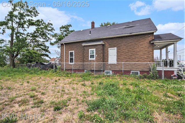 3620 Holborn St, Detroit, MI 48211 - back of house featuring brick siding and a chimney