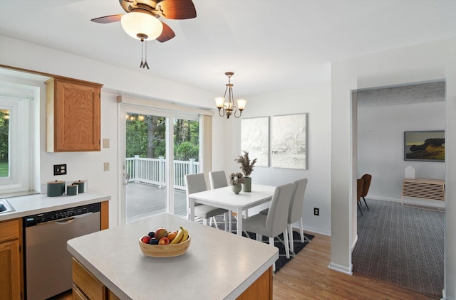 4540 Spinnaker Ln, Pleasant Lake, MI 49272 - kitchen with stainless steel dishwasher, brown cabinets, light countertops, and a chandelier