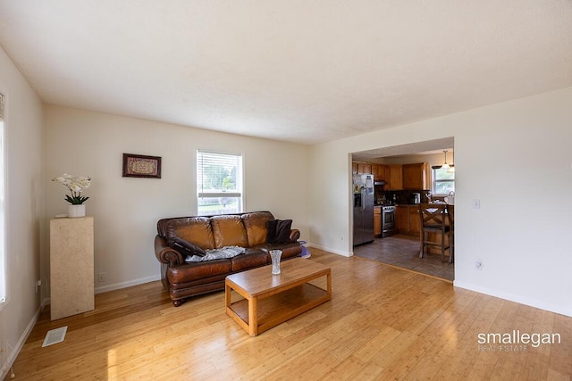 1591 Lillyview Ct SW, Wyoming, MI 49509 - living room with light wood-style flooring and baseboards