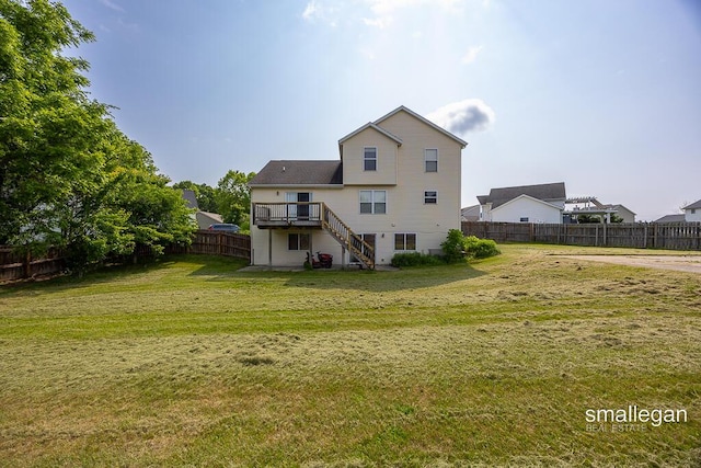 1591 Lillyview Ct SW, Wyoming, MI 49509 - back of property with stairway and a wooden deck