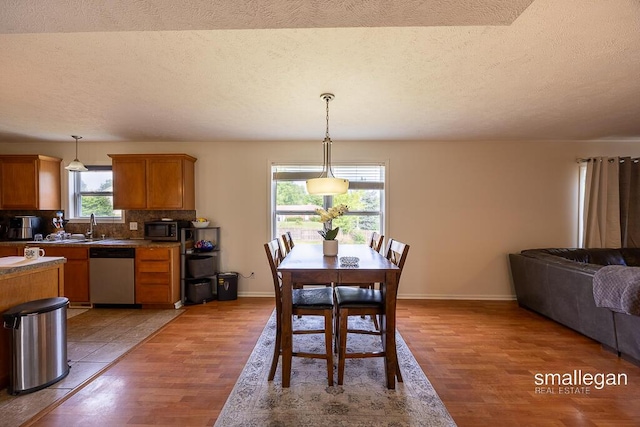 1591 Lillyview Ct SW, Wyoming, MI 49509 - dining area with light wood-type flooring and a textured ceiling