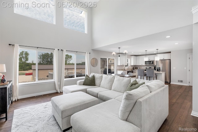 3923 Maple Ln, Auburn Hills, MI 48326 - living area featuring a towering ceiling, dark wood finished floors, a chandelier, and recessed lighting