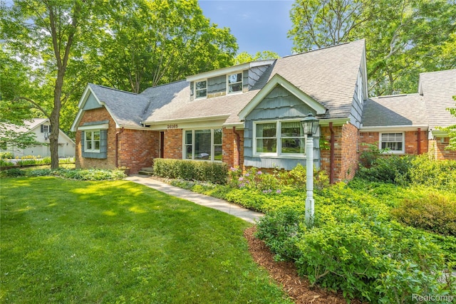 26165 Hidden Valley Dr, Farmington Hills, MI 48331 - view of front of home with a front lawn, brick siding, and roof with shingles