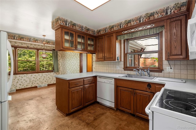 26165 Hidden Valley Dr, Farmington Hills, MI 48331 - kitchen featuring white appliances, wallpapered walls, a peninsula, brown cabinetry, and light countertops