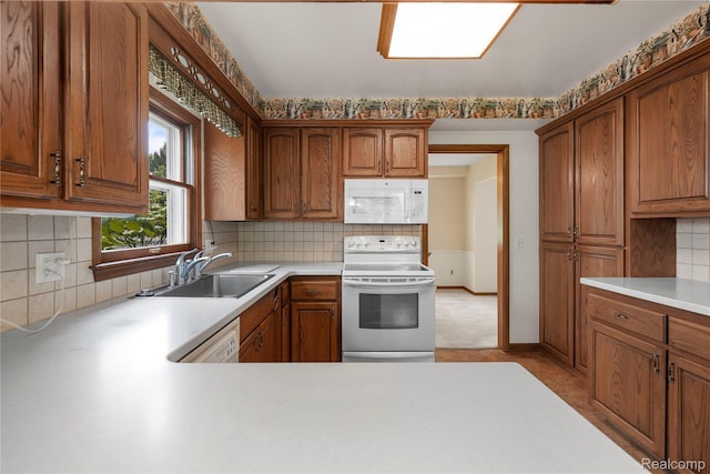 26165 Hidden Valley Dr, Farmington Hills, MI 48331 - kitchen featuring white appliances, light countertops, decorative backsplash, and brown cabinets