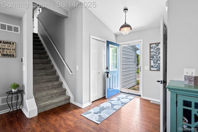 5031 Meadow Crest Cir, Holly, MI 48442 - entryway featuring wood finished floors, stairway, and vaulted ceiling