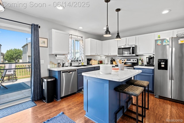 5031 Meadow Crest Cir, Holly, MI 48442 - kitchen featuring appliances with stainless steel finishes, a breakfast bar, a center island, white cabinetry, and recessed lighting