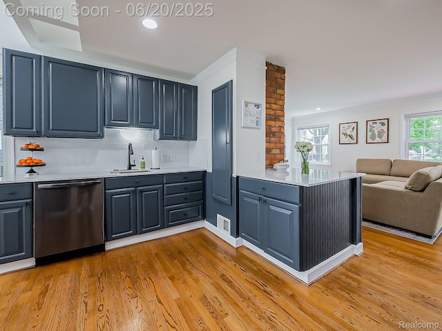 1036 Ferris Ave, Berkley, MI 48067 - kitchen with stainless steel dishwasher, a peninsula, light countertops, light wood-style flooring, and open floor plan