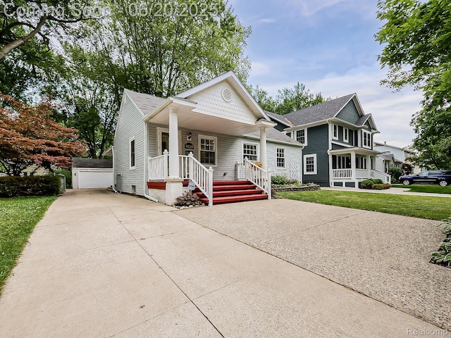 1036 Ferris Ave, Berkley, MI 48067 - view of front of property featuring a porch, an outbuilding, a shingled roof, a front lawn, and a detached garage