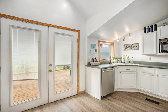 324 Cranson Rd, Bronson, MI 49028 - kitchen with stainless steel dishwasher, lofted ceiling, black microwave, white cabinetry, and light wood-type flooring