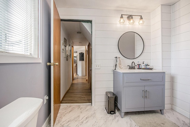 324 Cranson Rd, Bronson, MI 49028 - bathroom with marble finish flooring, vanity, and wood walls