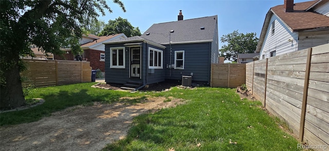 1154 Lincoln Ave, Rockwood, MI 48146 - back of house with entry steps, a fenced backyard, and a chimney