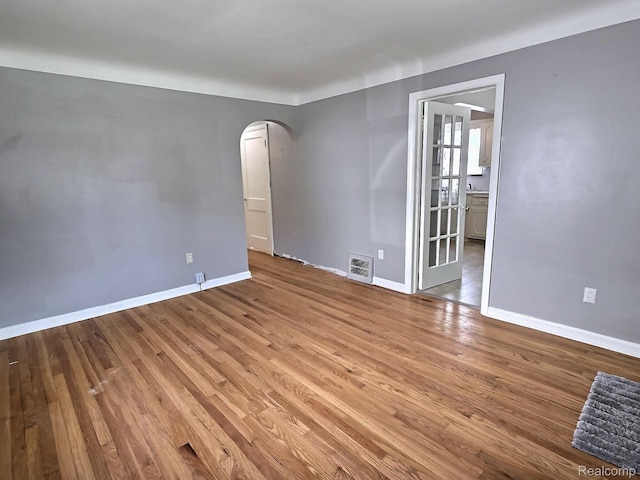 1154 Lincoln Ave, Rockwood, MI 48146 - unfurnished room with arched walkways and wood finished floors