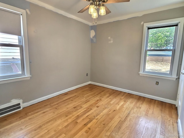1154 Lincoln Ave, Rockwood, MI 48146 - spare room featuring light wood finished floors, a ceiling fan, and ornamental molding