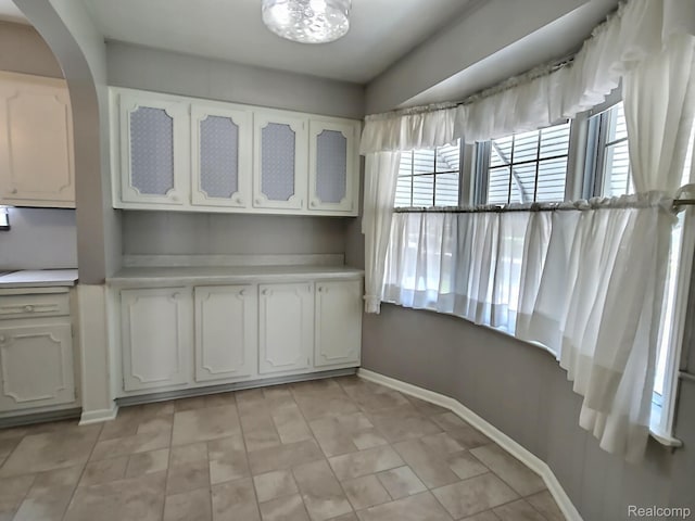 1154 Lincoln Ave, Rockwood, MI 48146 - unfurnished dining area with arched walkways and light tile patterned flooring