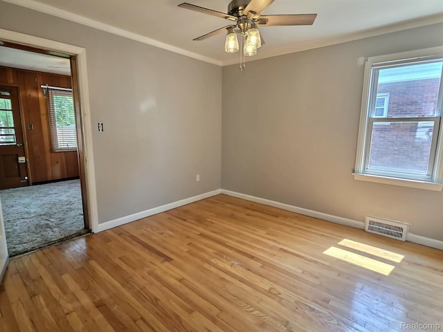 1154 Lincoln Ave, Rockwood, MI 48146 - empty room with healthy amount of natural light, light wood-style flooring, crown molding, and ceiling fan
