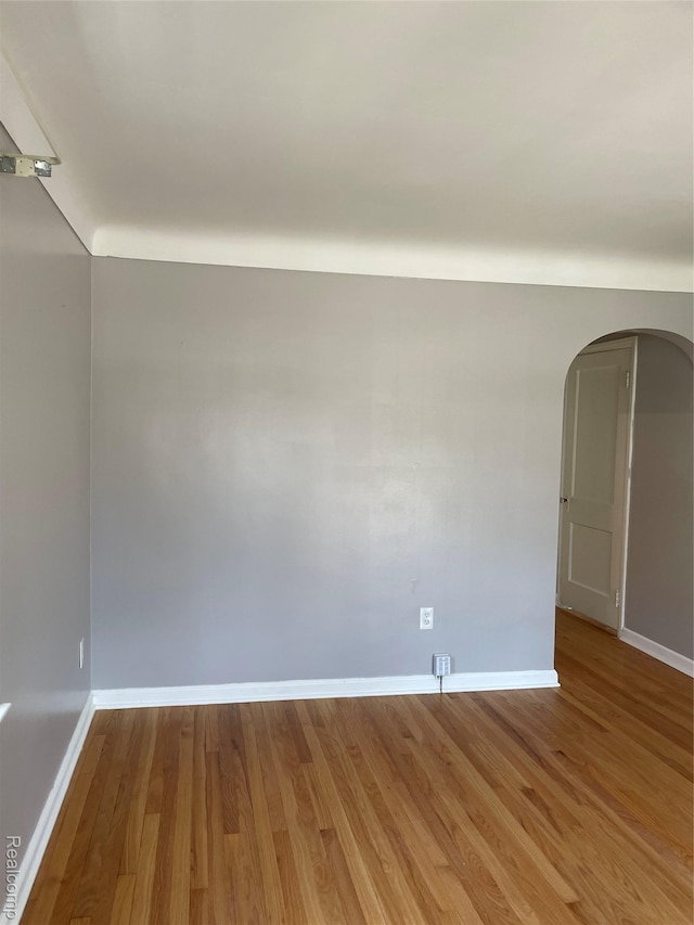1154 Lincoln Ave, Rockwood, MI 48146 - empty room with arched walkways and wood finished floors