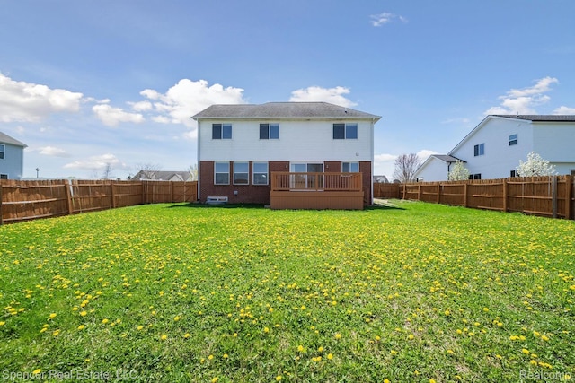 61 Old Carriage Ln, Lapeer, MI 48446 - rear view of property featuring a fenced backyard, brick siding, and a deck