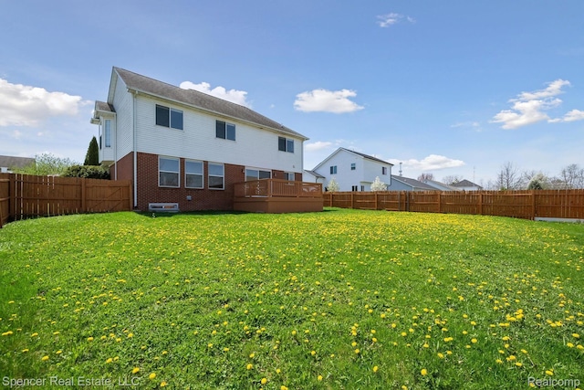 61 Old Carriage Ln, Lapeer, MI 48446 - back of house with brick siding and a fenced backyard