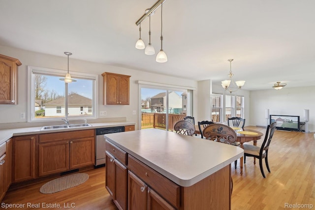 61 Old Carriage Ln, Lapeer, MI 48446 - kitchen featuring stainless steel dishwasher, a chandelier, light wood-style floors, and decorative light fixtures