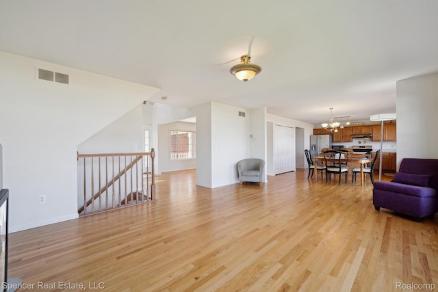 61 Old Carriage Ln, Lapeer, MI 48446 - living room featuring a chandelier and light wood-style floors