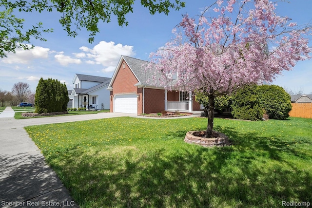 61 Old Carriage Ln, Lapeer, MI 48446 - view of front of home featuring concrete driveway, a front lawn, a garage, and brick siding