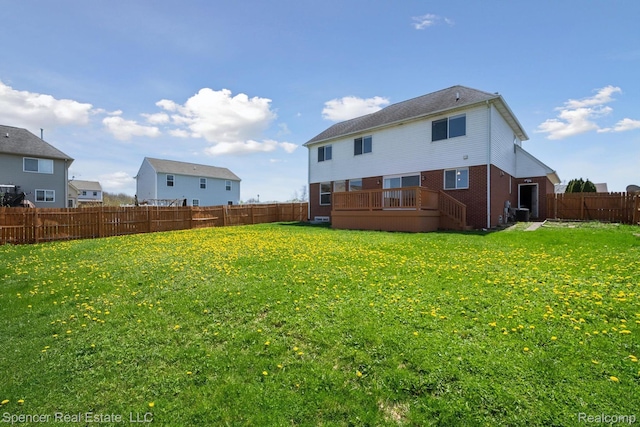 61 Old Carriage Ln, Lapeer, MI 48446 - rear view of house featuring brick siding, a fenced backyard, and a wooden deck