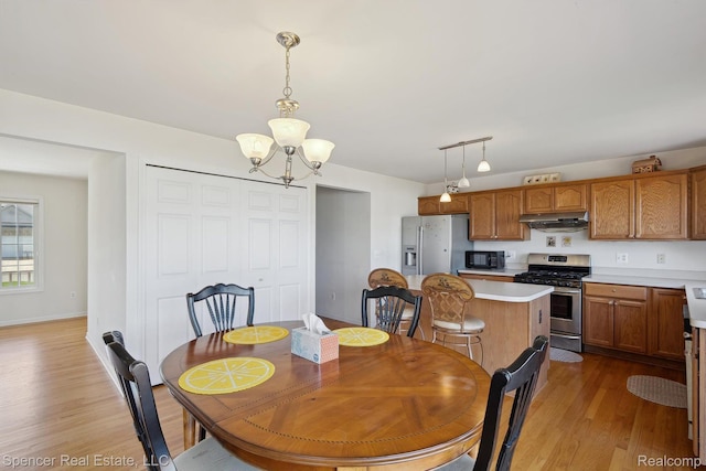 61 Old Carriage Ln, Lapeer, MI 48446 - dining room featuring a chandelier and light wood-style flooring