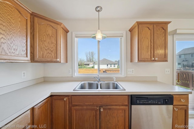 61 Old Carriage Ln, Lapeer, MI 48446 - kitchen with stainless steel dishwasher, plenty of natural light, light countertops, and pendant lighting